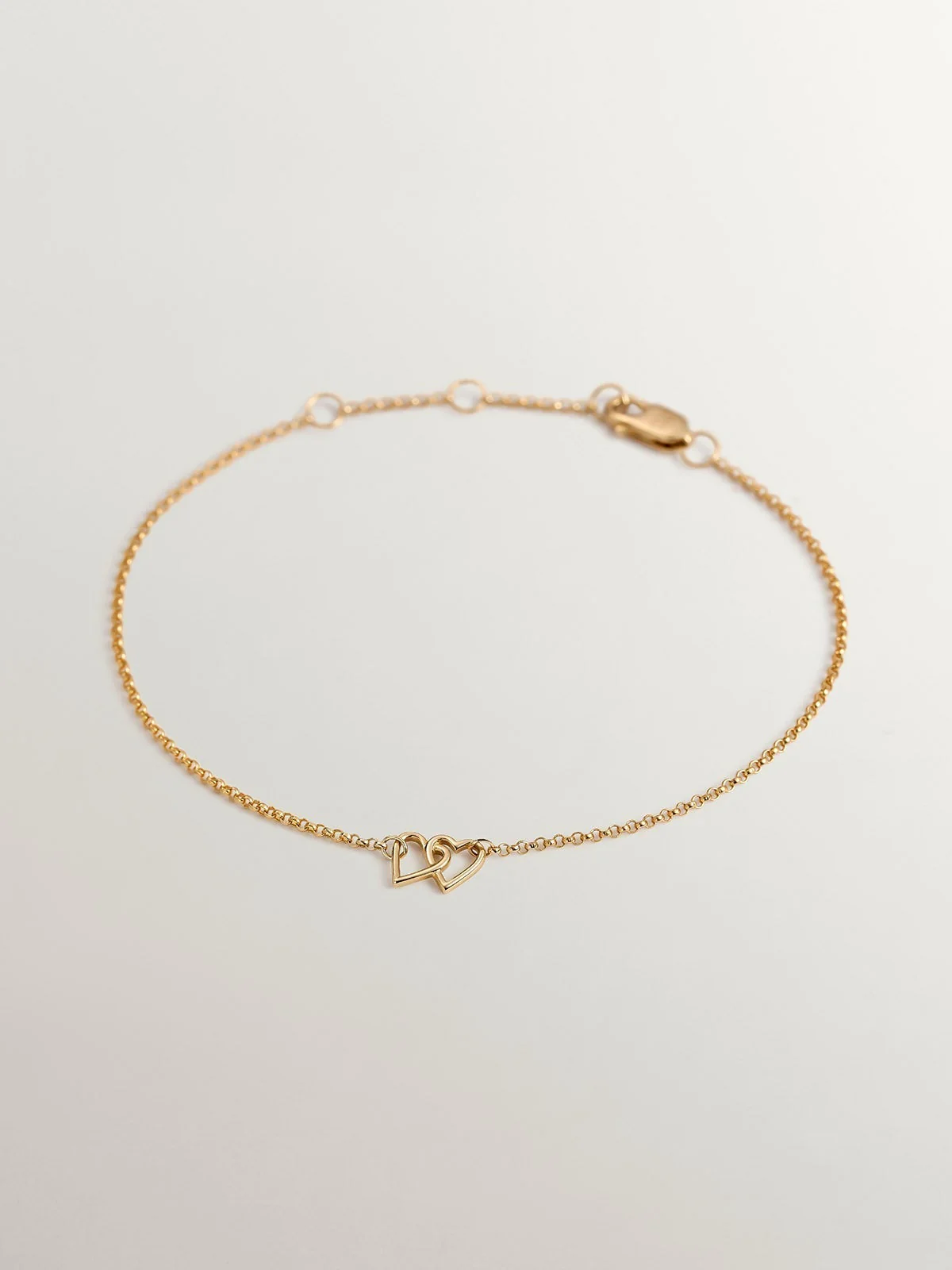 Pulsera de oro amarillo de 9K con corazones entrelazados