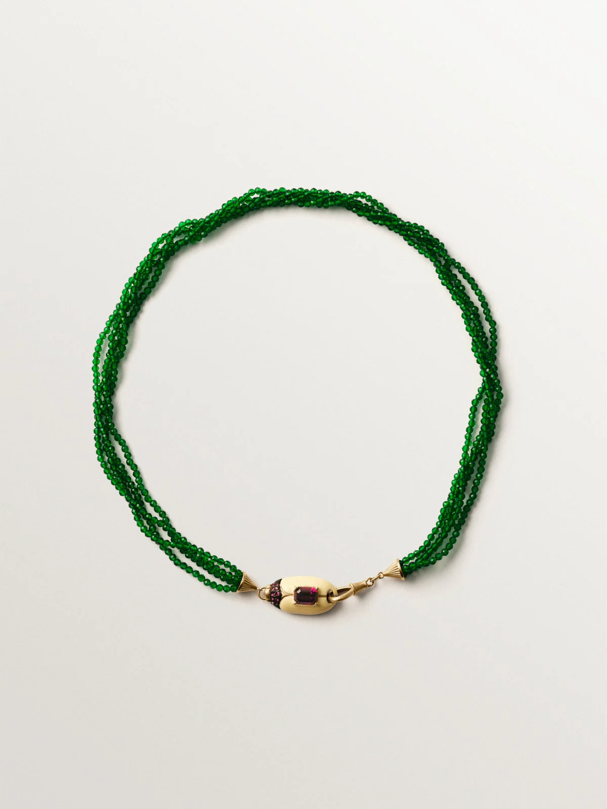 Yellow gold-plated necklace with green crystal beads and beetle shape with purple crystals